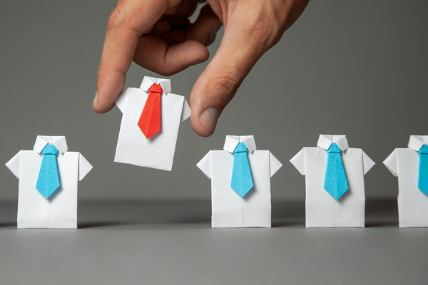 Miniature dress shirts with ties made out of paper.